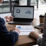 Business consultants reviewing strategy documents and charts during a meeting